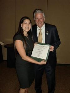 Dr. Stephanie Woo receiving her FAAO with Dr. Ed. Bennett