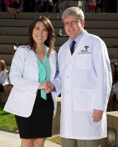 Maggie at the Class of 2016 White Coat Ceremony being congratulated by MBKU President, Dr. Kevin Alexander