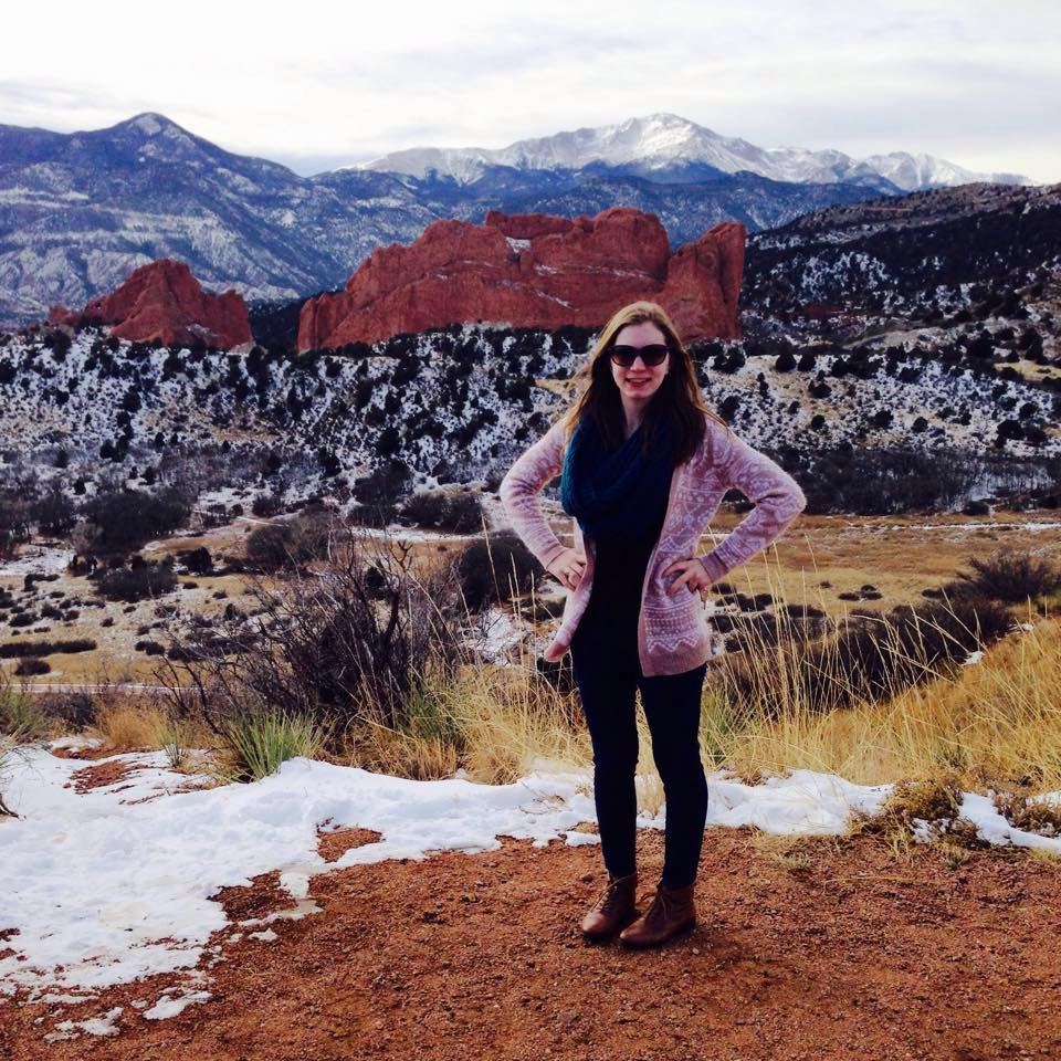 Me in my hometown Colorado Springs with Garden of the Gods and Pike's Peak behind me